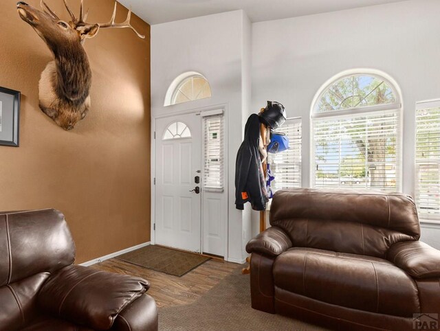 entryway with wood finished floors and baseboards