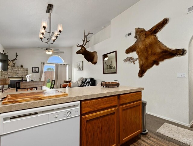 kitchen featuring hanging light fixtures, white dishwasher, light countertops, and open floor plan