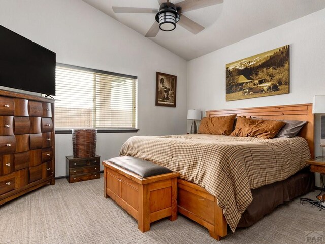 bedroom with light carpet, ceiling fan, and lofted ceiling