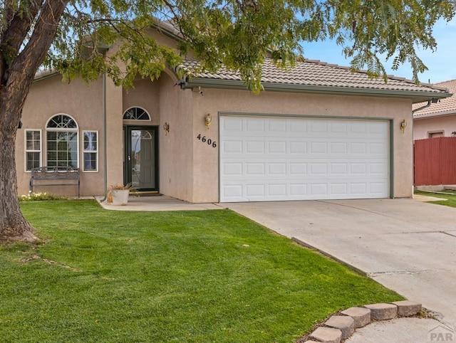 view of front facade featuring a front yard, a tile roof, and stucco siding