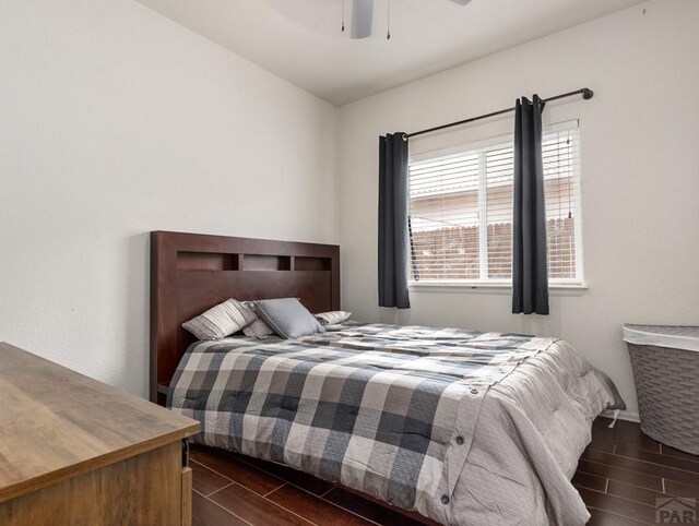 bedroom with a ceiling fan and wood finish floors