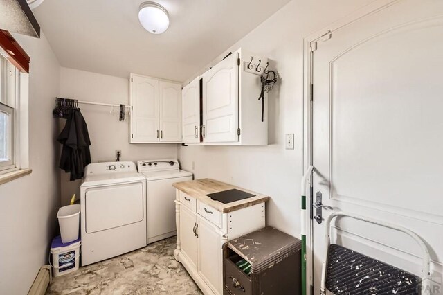 laundry room featuring cabinet space, a baseboard radiator, and washer and dryer