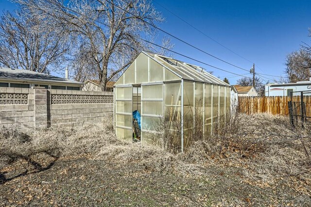 view of greenhouse with fence private yard