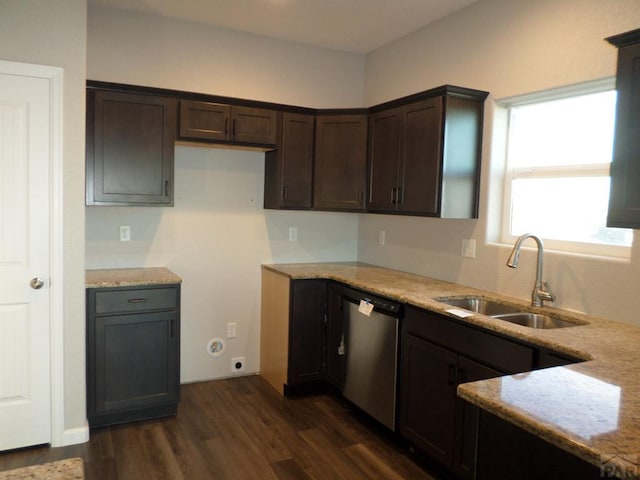 kitchen with dark wood-style flooring, a sink, light stone countertops, dark brown cabinets, and stainless steel dishwasher