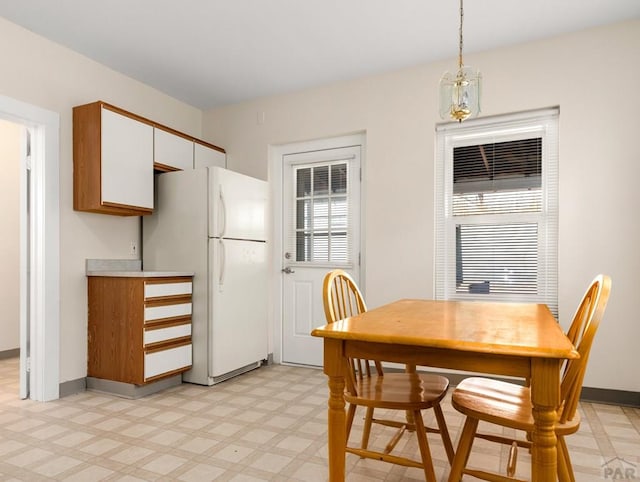 dining area with light floors and baseboards