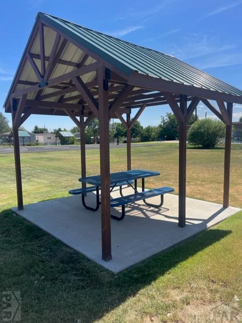 view of property's community with a gazebo, a lawn, and a patio