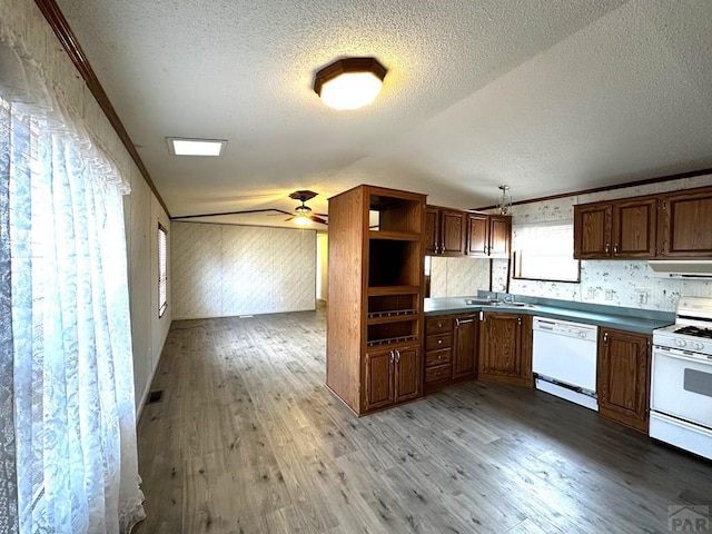 kitchen featuring white appliances, ornamental molding, light wood-type flooring, open shelves, and a sink