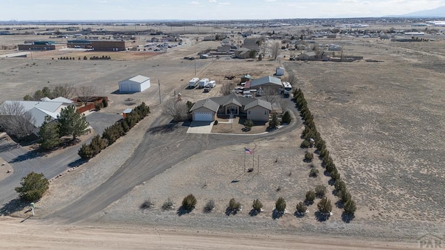 drone / aerial view featuring a desert view and a rural view