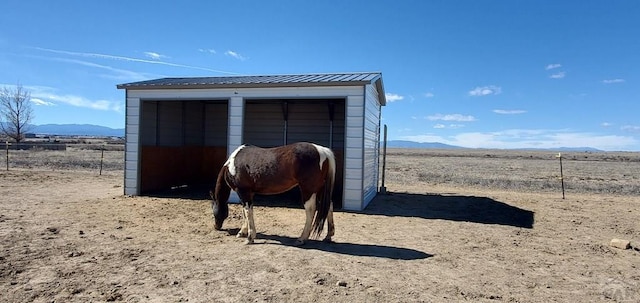 view of horse barn with a mountain view