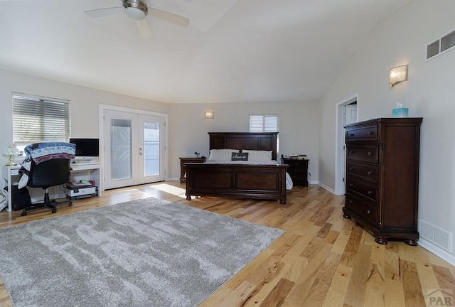 bedroom featuring lofted ceiling, light wood-style flooring, visible vents, and access to exterior