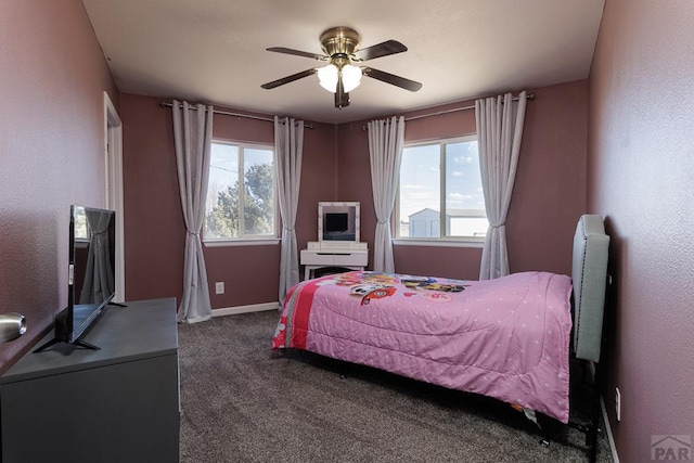 bedroom with ceiling fan, carpet floors, multiple windows, and baseboards