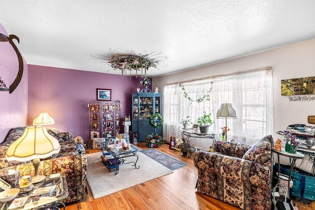 living room with wood finished floors and a textured ceiling