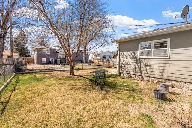 view of yard with a fenced backyard and a residential view