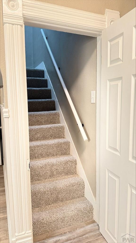 stairway with wood finished floors