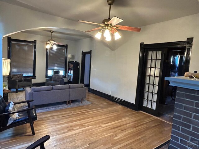 2707 4th Ave, Pueblo, CO 81003 - living room featuring ceiling fan, arched walkways, wood finished floors, and baseboards