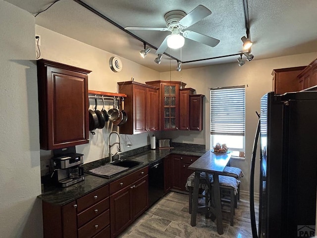 2707 4th Ave, Pueblo, CO 81003 - kitchen featuring black appliances, rail lighting, a ceiling fan, glass insert cabinets, and a sink
