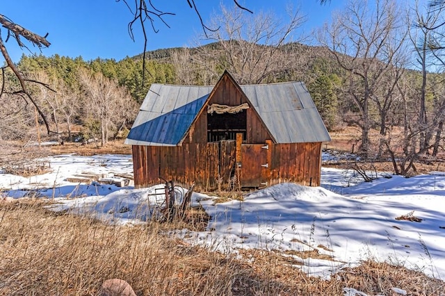 exterior space with a mountain view and an outdoor structure