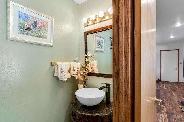 bathroom with a sink and wood finished floors