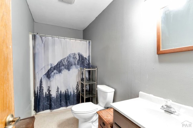 bathroom featuring toilet, a shower with curtain, and vanity