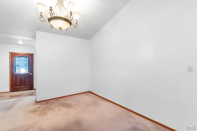 interior space with baseboards and a notable chandelier