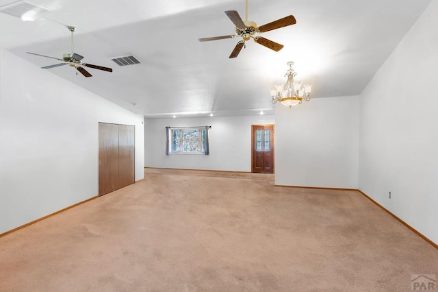 unfurnished room featuring visible vents, baseboards, lofted ceiling, carpet, and ceiling fan with notable chandelier