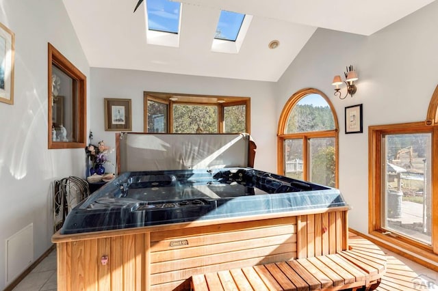 misc room featuring visible vents, vaulted ceiling, and light tile patterned floors