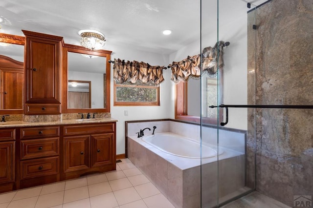 bathroom with double vanity, tile patterned floors, a garden tub, a shower stall, and a sink