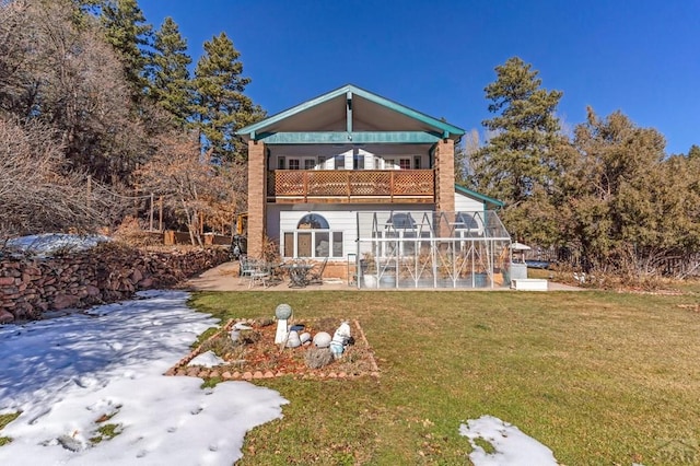 back of house with a patio, a balcony, and a lawn