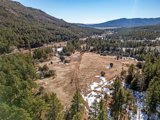 bird's eye view with a mountain view and a wooded view