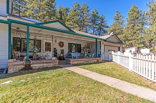 view of front facade with a garage, covered porch, fence, and a front lawn