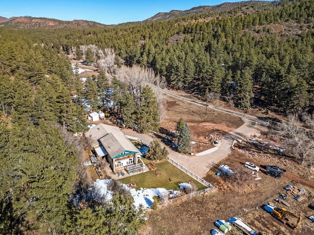 aerial view with a wooded view and a mountain view