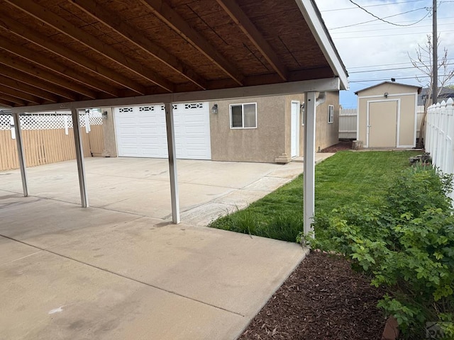 1326 E River St, Pueblo, CO 81001 - view of patio / terrace featuring an outdoor structure, fence, and a shed