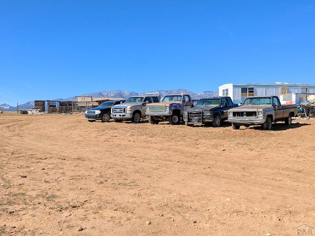 view of vehicle parking featuring a mountain view