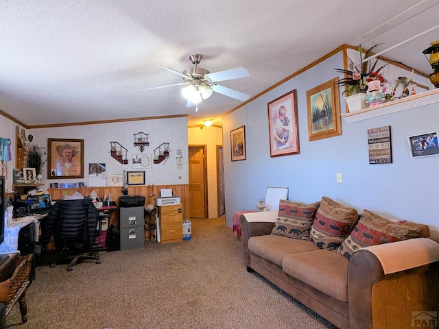 carpeted office featuring a textured ceiling, ornamental molding, and a ceiling fan