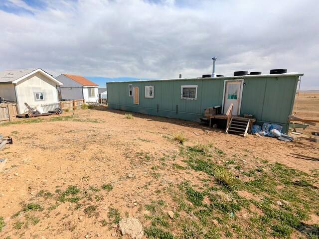 rear view of property featuring fence