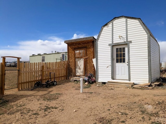 view of outbuilding featuring an outdoor structure and fence