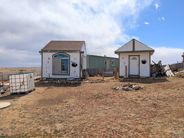 view of outbuilding with an outbuilding and fence