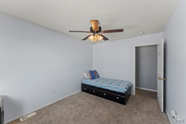 bedroom with carpet floors, visible vents, baseboards, and a ceiling fan