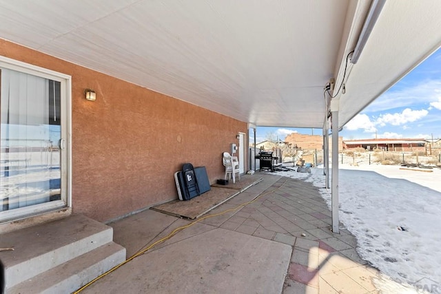 snow covered patio featuring entry steps