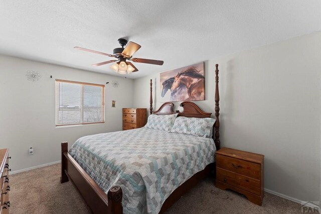 carpeted bedroom with baseboards and a ceiling fan