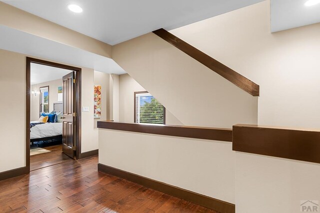 hall with dark wood-style floors, recessed lighting, and baseboards