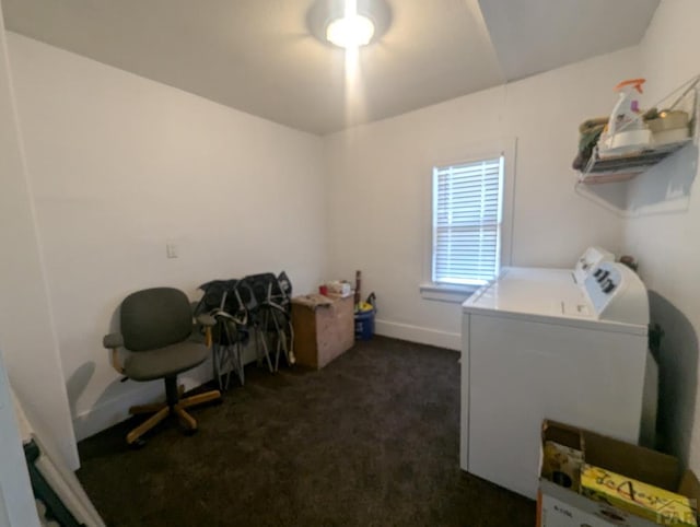 clothes washing area with laundry area, dark colored carpet, washing machine and dryer, and baseboards