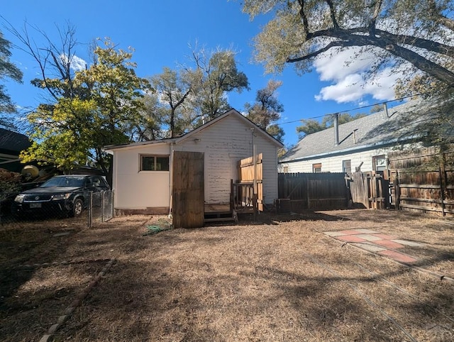 back of house with cooling unit and fence