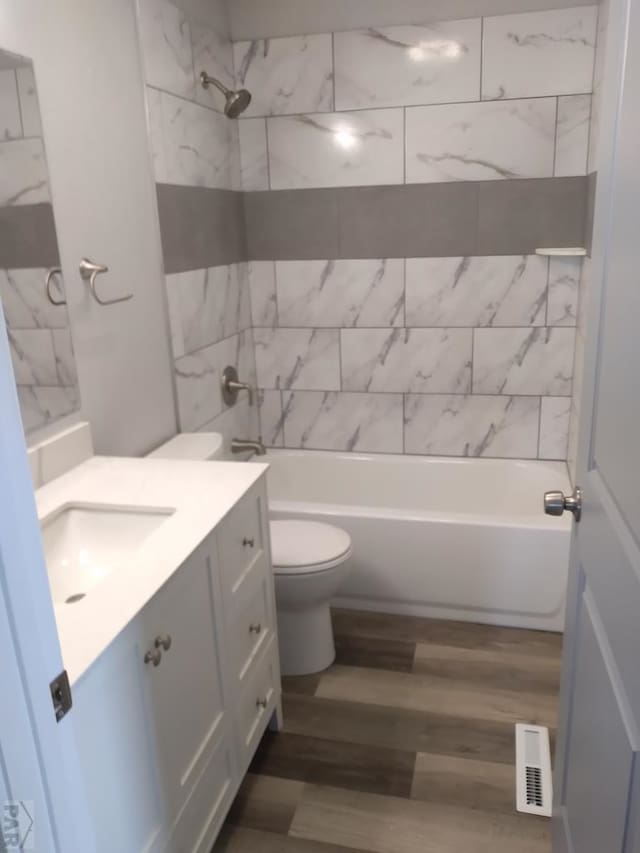 1708 W 8th St, Las Animas, CO 81054 - full bath featuring vanity, wood finished floors, and washtub / shower combination