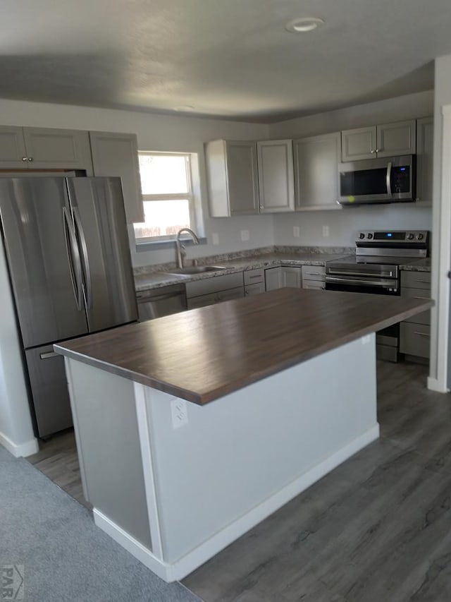 1708 W 8th St, Las Animas, CO 81054 - kitchen featuring appliances with stainless steel finishes, wood counters, gray cabinets, and a kitchen island