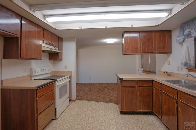 1021 7th St, Walsenburg, CO 81089 - kitchen featuring a sink, electric stove, light countertops, and brown cabinets
