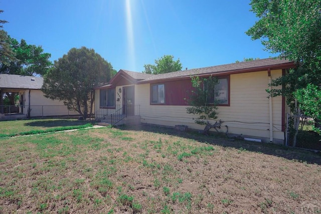 1021 7th St, Walsenburg, CO 81089 - single story home featuring fence and a front lawn