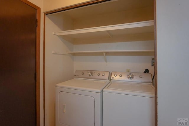 washroom featuring washing machine and dryer