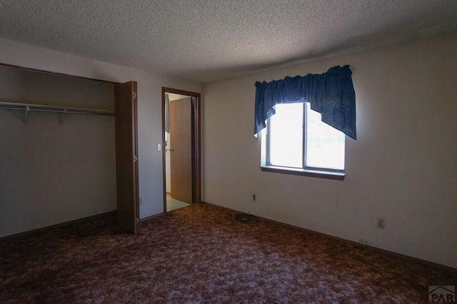 unfurnished bedroom with carpet floors, a closet, and a textured ceiling