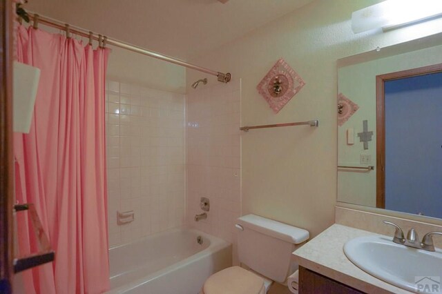 1021 7th St, Walsenburg, CO 81089 - full bathroom featuring toilet, shower / bath combo with shower curtain, and vanity